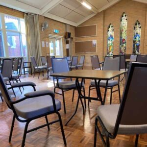 The Burke Road hall with chairs and tables