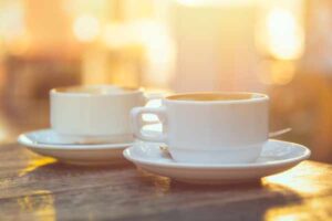 two cups of coffee on a wooden table