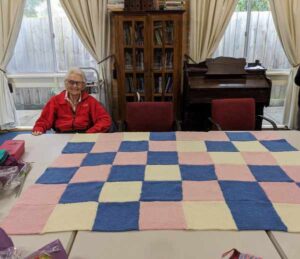 pink and blue rug made from kitted squares by Craft Group in Stonnington