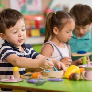 Three children at kindergarten doing activity